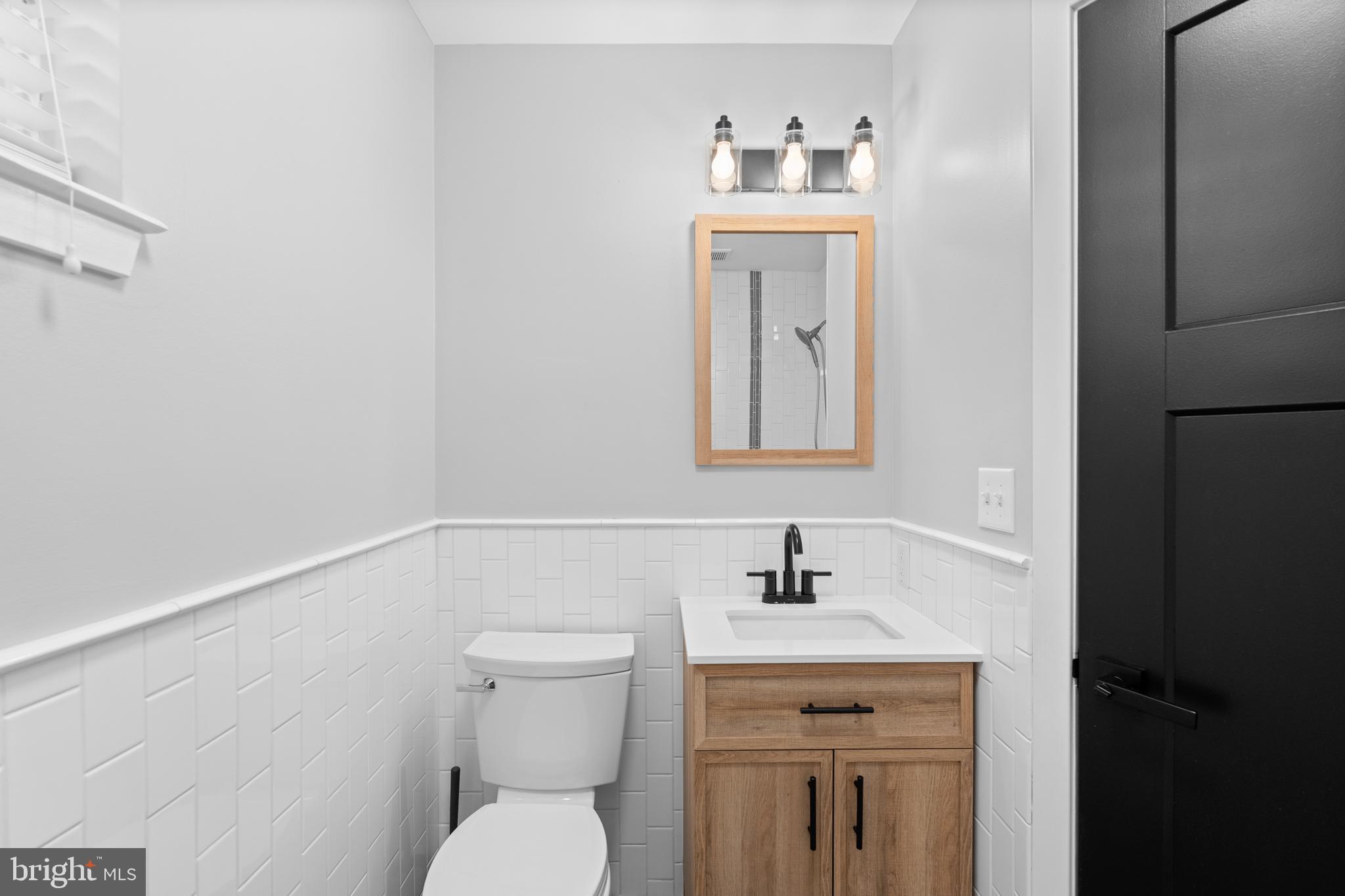 345 Roseberry Street Philadelphia, PA 19148 - Photo 23 of 30 a bathroom with a toilet sink and mirror