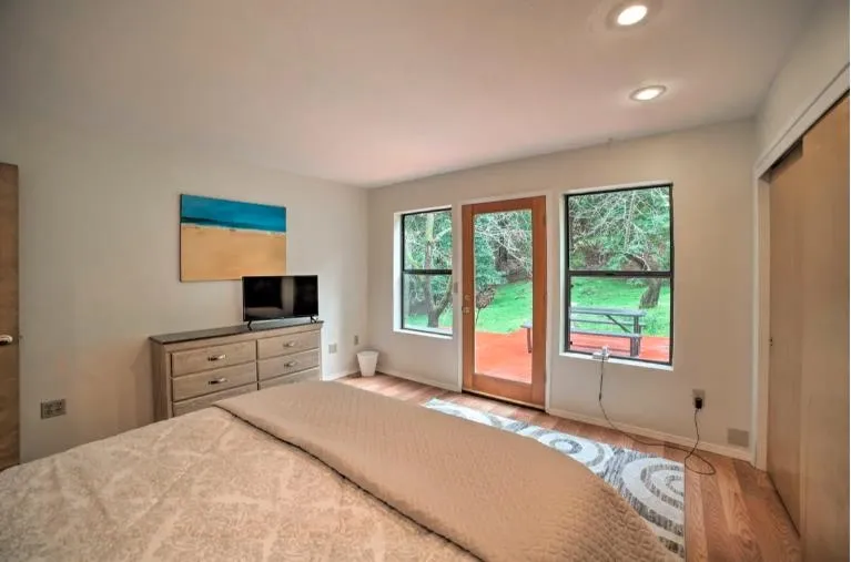 16885 Laurel Road Los Gatos, CA 95033 - Photo 12 of 40 a bedroom with a large bed and a flat tv screen on dresser