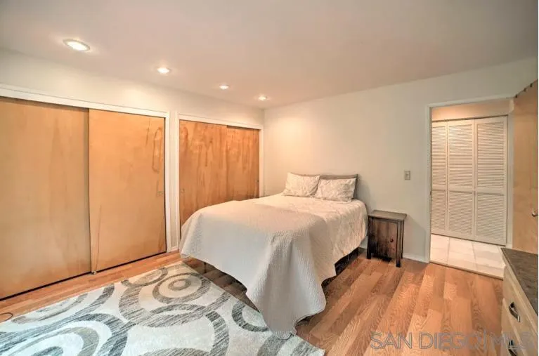 16885 Laurel Road Los Gatos, CA 95033 - Photo 13 of 40 a bedroom with a large bed and wooden floor