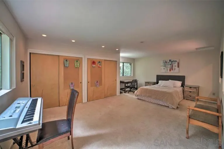 16885 Laurel Road Los Gatos, CA 95033 - Photo 15 of 40 a spacious bedroom with a bed and furniture