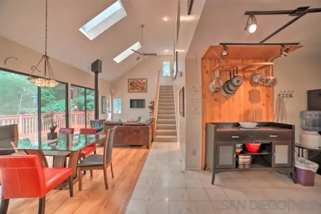 a living room with furniture a flat screen tv and a large window