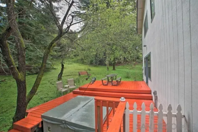 a backyard of a house with yard table and chairs