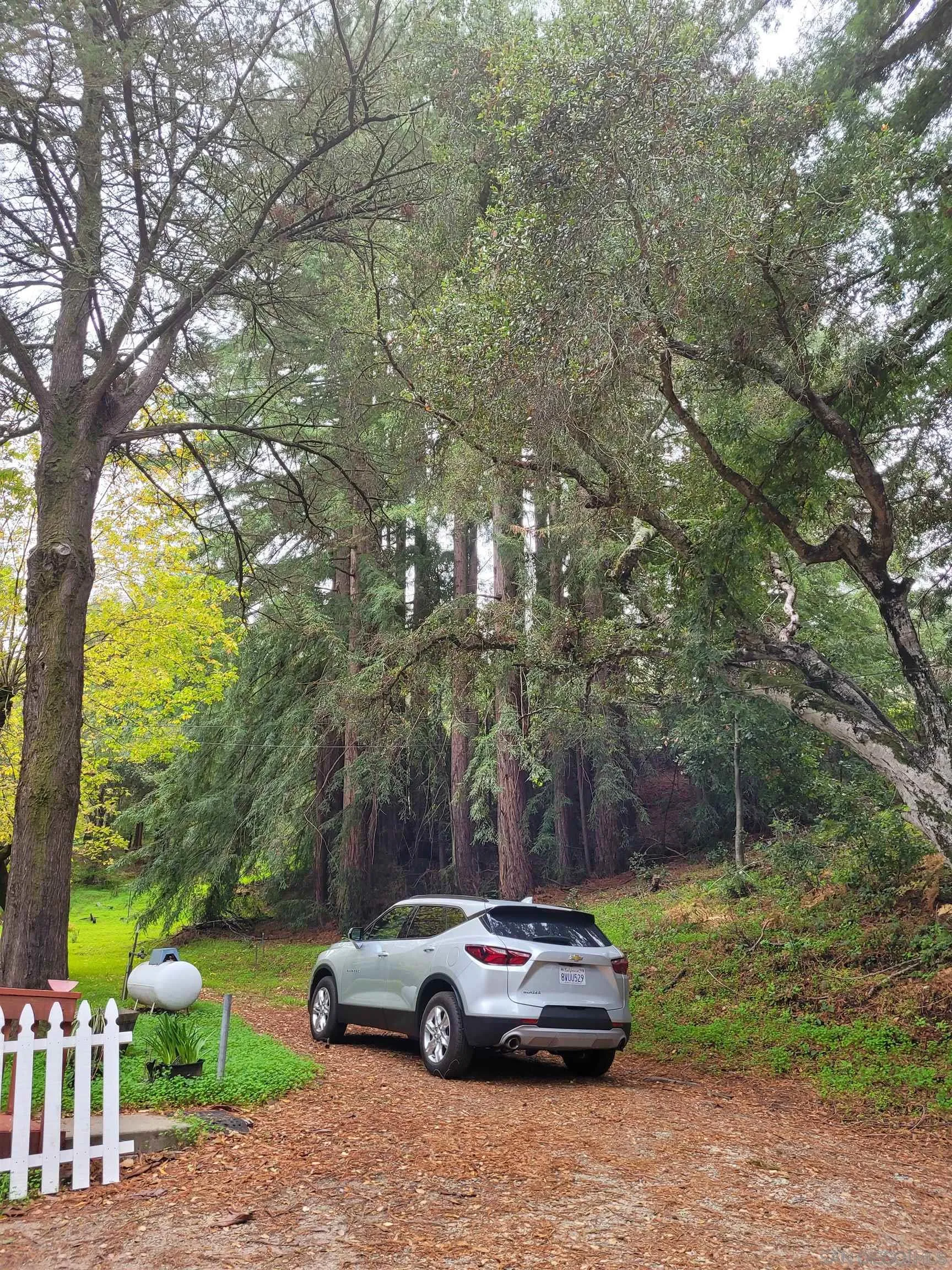 16885 Laurel Road Los Gatos, CA 95033 - Photo 28 of 40 a car parked in front of a white house