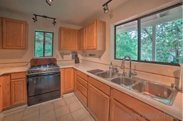 a kitchen with a sink stove and cabinets