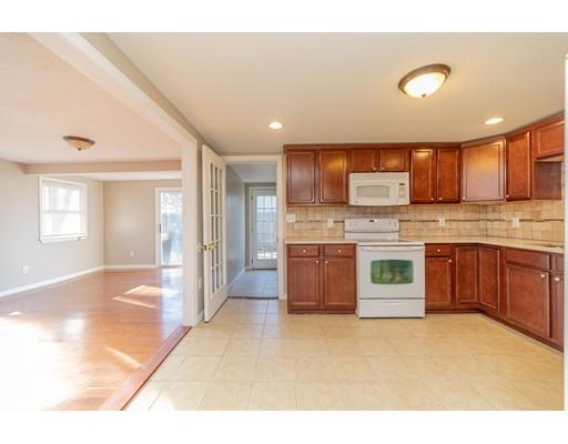 28 Barnet Street Springfield, MA 01129 - Photo 11 of 26 a large kitchen with stainless steel appliances granite countertop a sink and cabinets