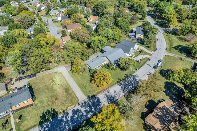 an aerial view of a house with a yard and lake view
