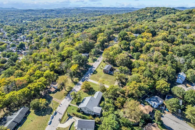 an aerial view of a house with a yard