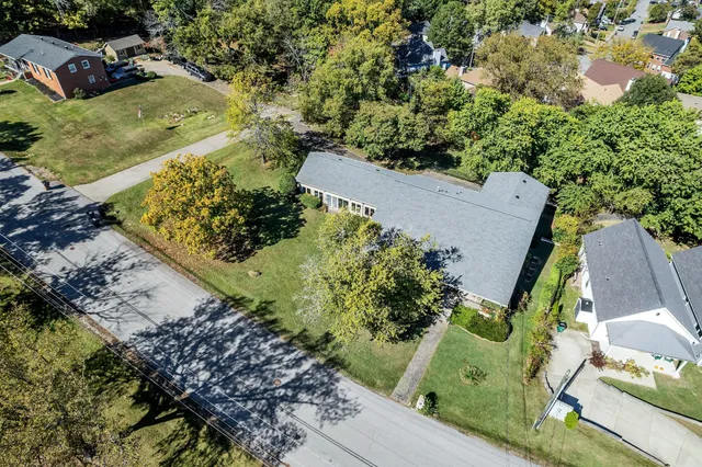 an aerial view of a house with a yard