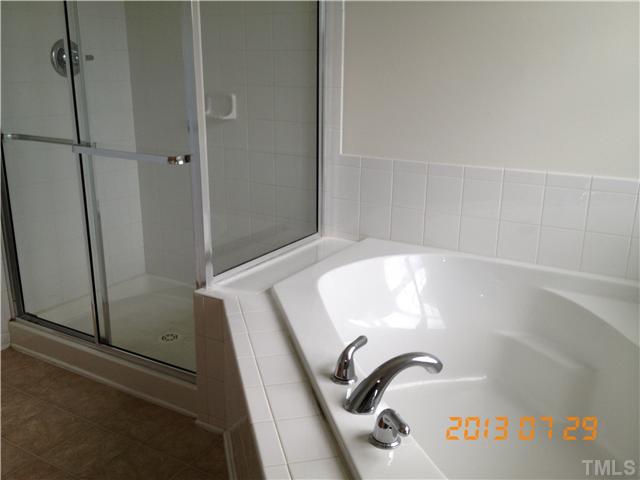 4902 Midstone Lane Raleigh, NC 27610 - Photo 5 of 7 a bathroom with a bathtub and shower