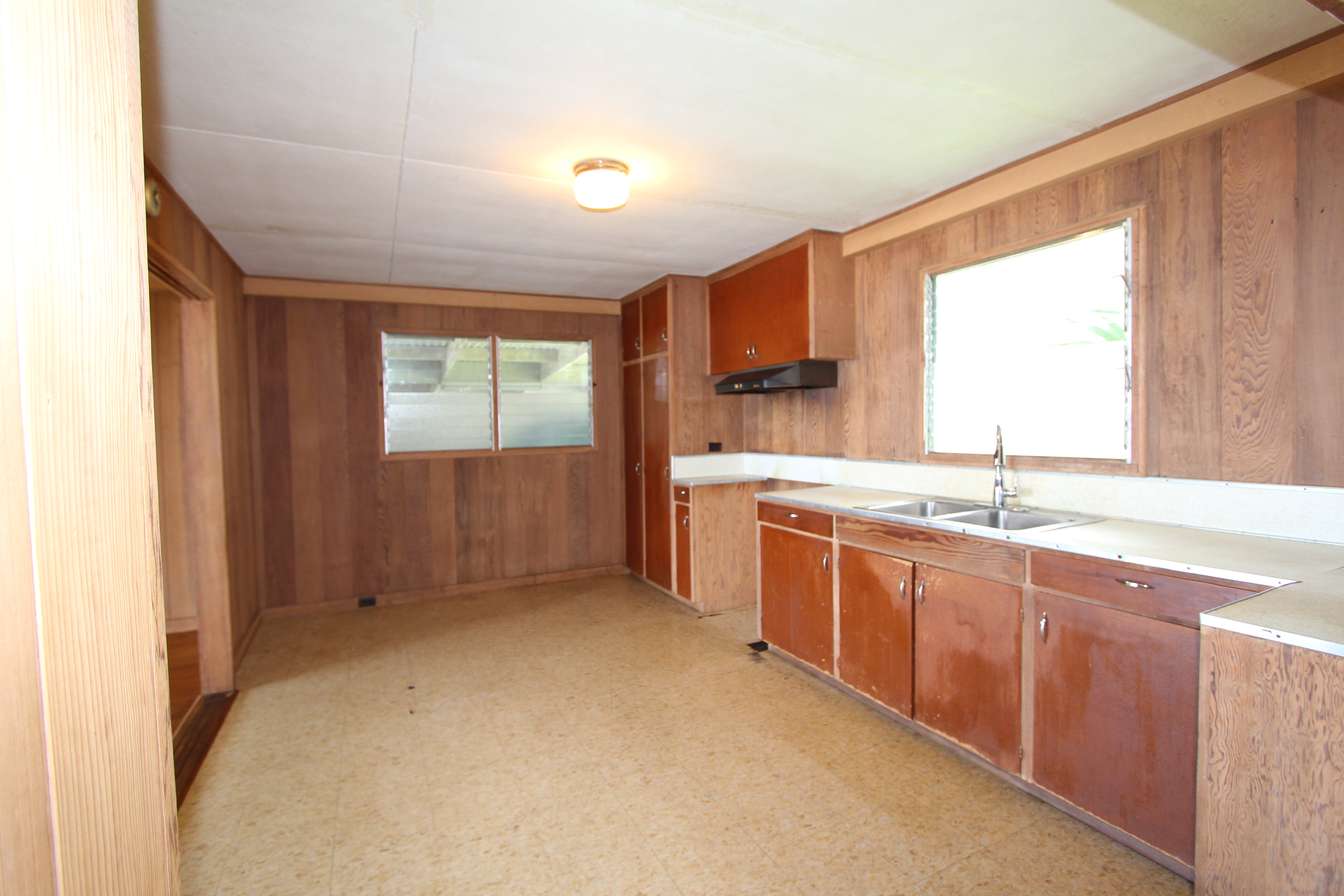 82-1025 Kinue Road Captain Cook, HI 96704 - Photo 4 of 12 a kitchen with stainless steel appliances granite countertop a sink and a stove