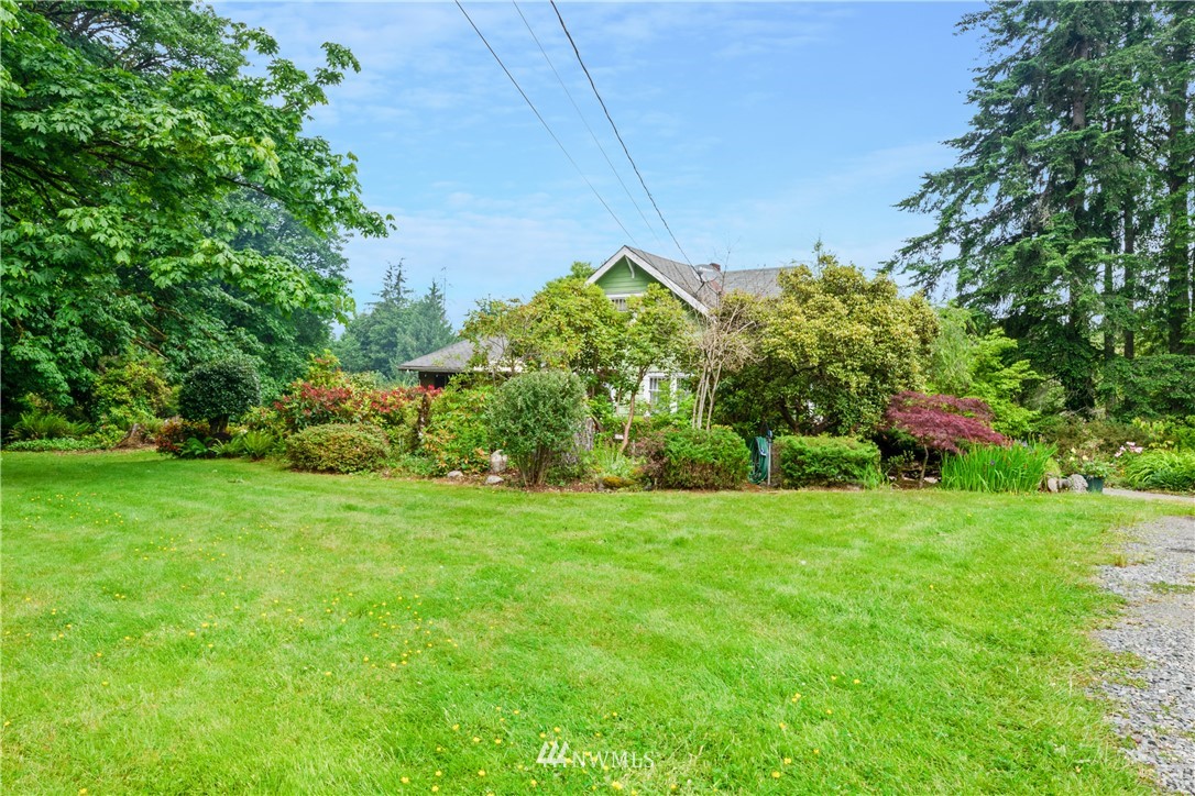 16825 Three Lakes Road Snohomish, WA 98290 - Photo 2 of 32 a view of a garden with a building in the background