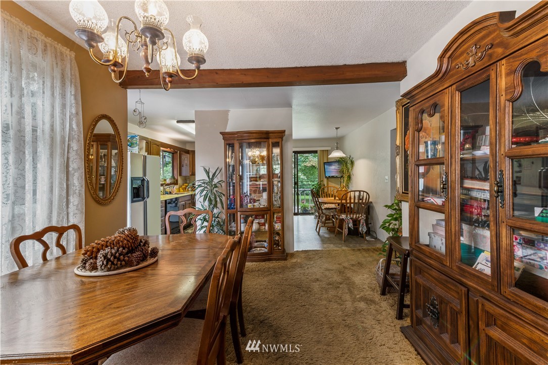 16825 Three Lakes Road Snohomish, WA 98290 - Photo 11 of 32 a view of a dining room with furniture and chandelier