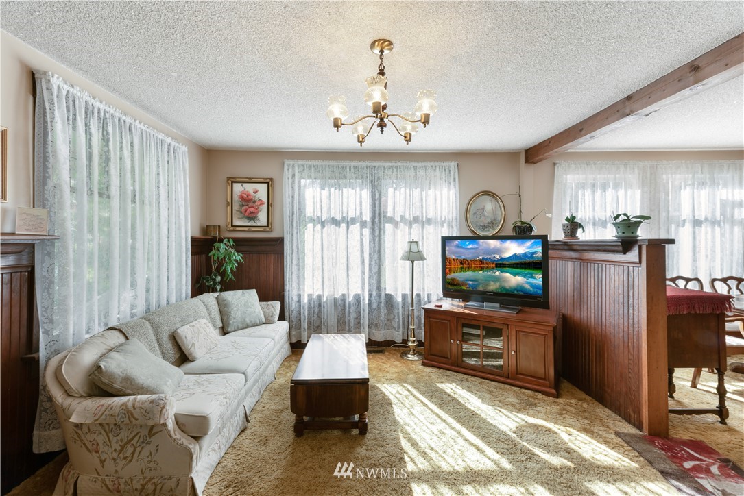 16825 Three Lakes Road Snohomish, WA 98290 - Photo 12 of 32 a living room with furniture a window and a flat screen tv