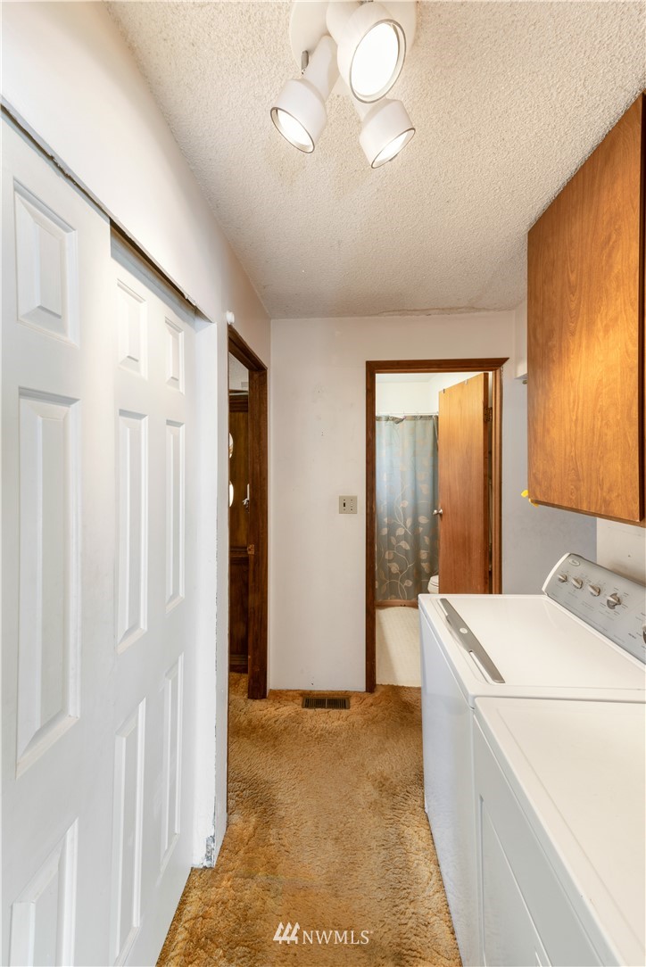 16825 Three Lakes Road Snohomish, WA 98290 - Photo 14 of 32 a view of washer and dryer with bathroom in the background