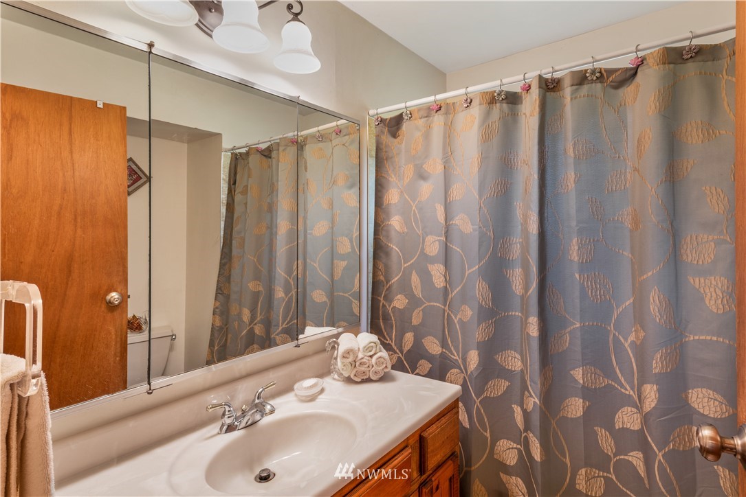 16825 Three Lakes Road Snohomish, WA 98290 - Photo 15 of 32 a bathroom with a sink and a mirror