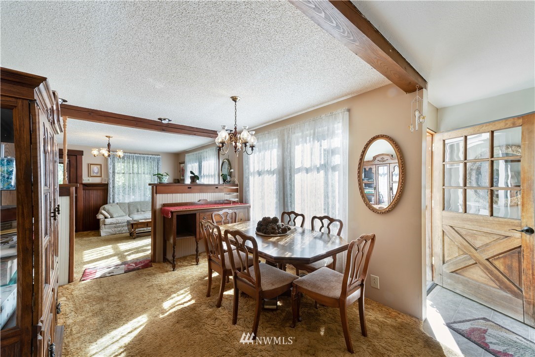 16825 Three Lakes Road Snohomish, WA 98290 - Photo 10 of 32 a view of a dining room with furniture window and wooden floor