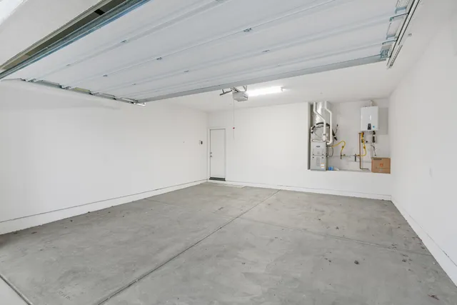 a patio with a table and chairs potted plants and a palm tree
