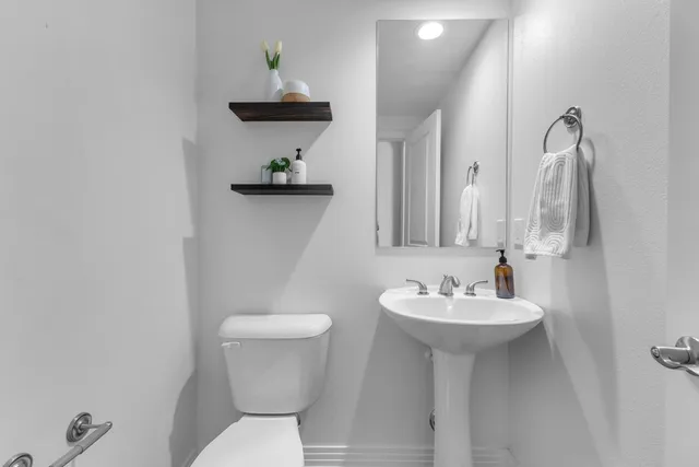 a bathroom with a sink a vanity and a window