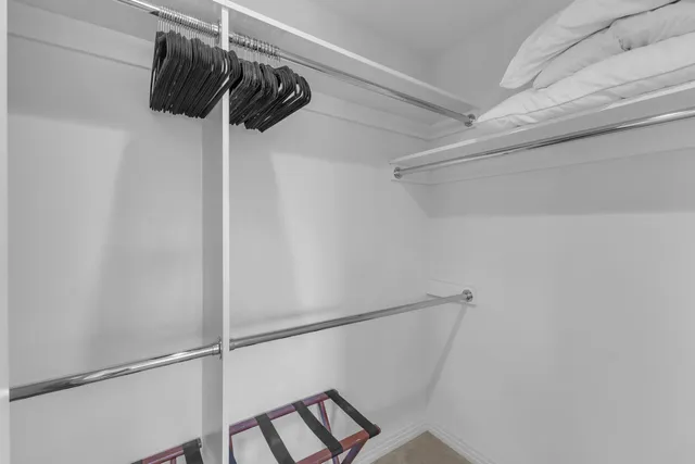 wooden floor with a potted plant on the table and a mirror