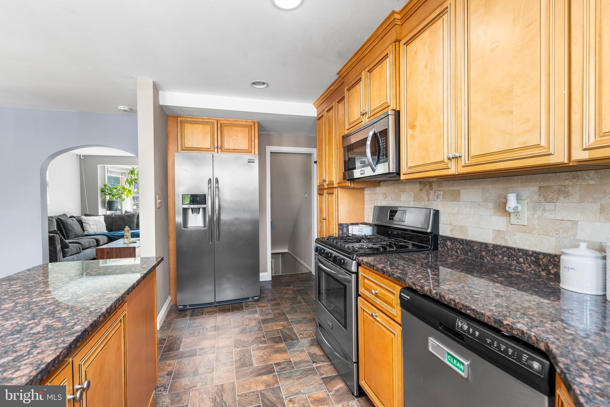 1606 Loch Ness Road Baltimore, MD 21286 - Photo 11 of 36 a kitchen with stainless steel appliances granite countertop a stove a sink and a refrigerator
