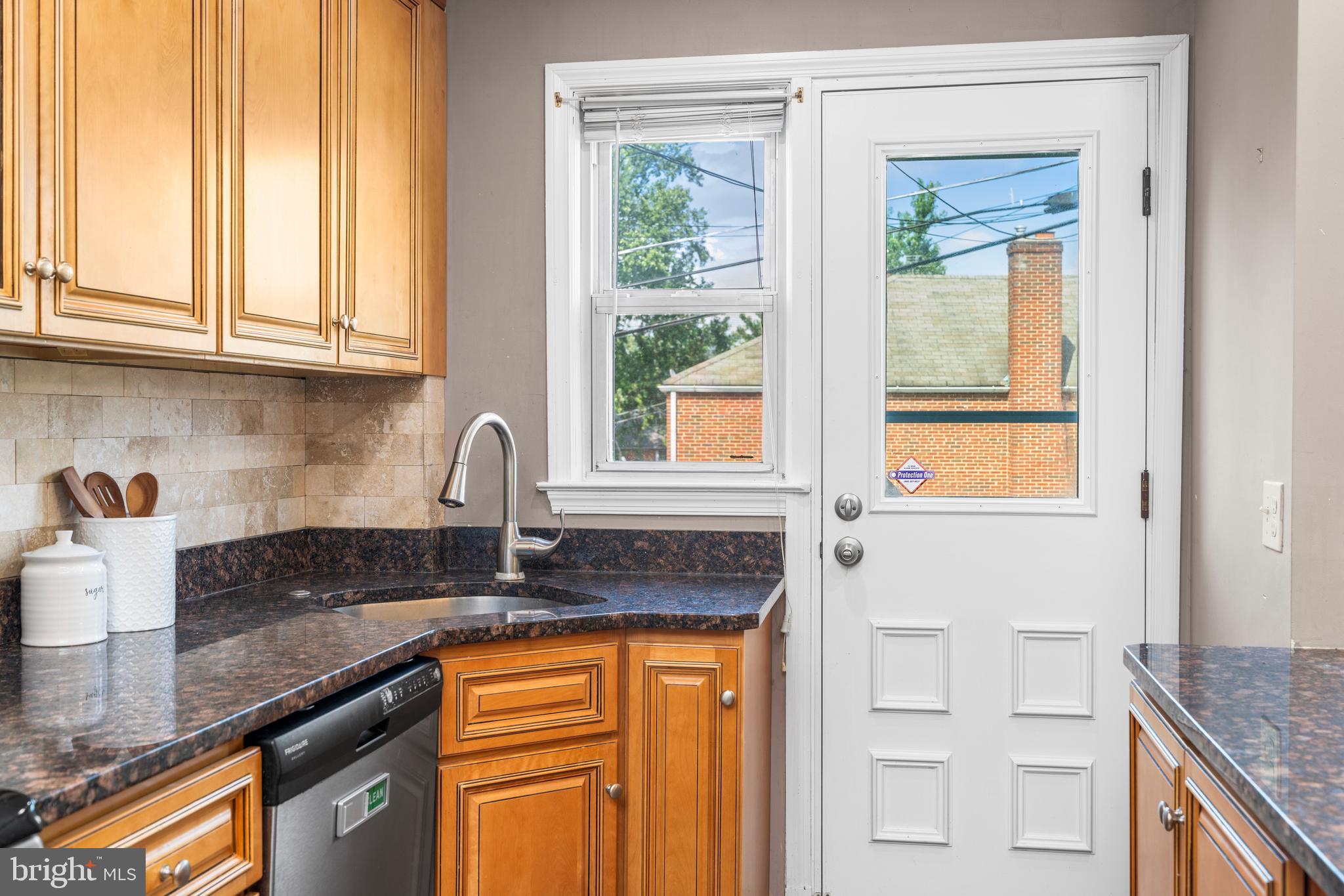 1606 Loch Ness Road Baltimore, MD 21286 - Photo 12 of 36 a kitchen with granite countertop a sink and a window
