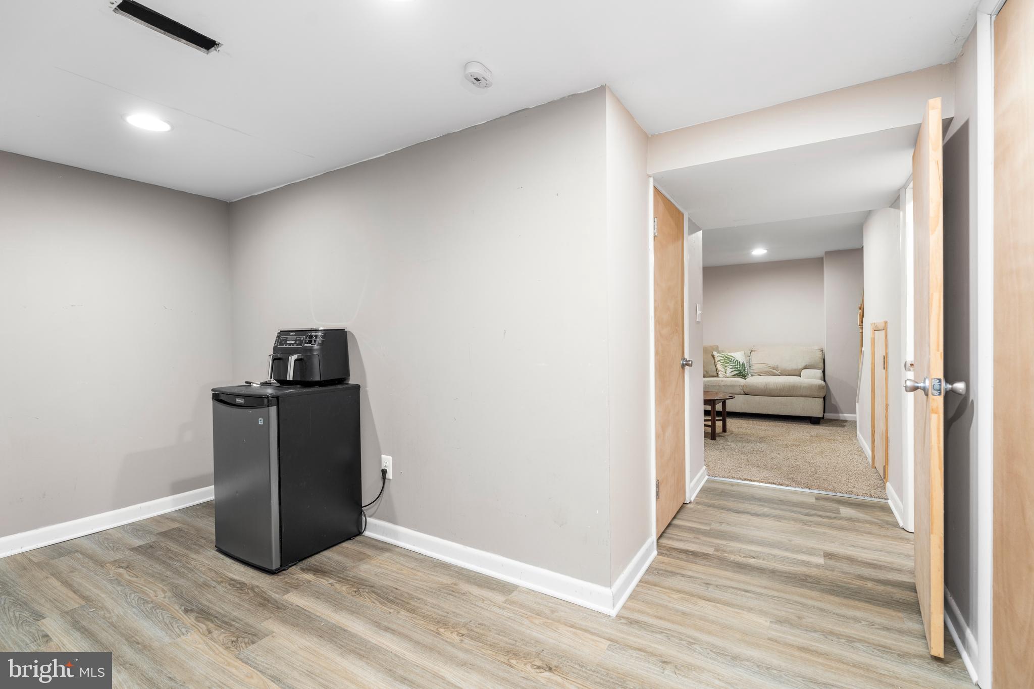 1606 Loch Ness Road Baltimore, MD 21286 - Photo 27 of 36 a view of a hallway with wooden floor and furniture