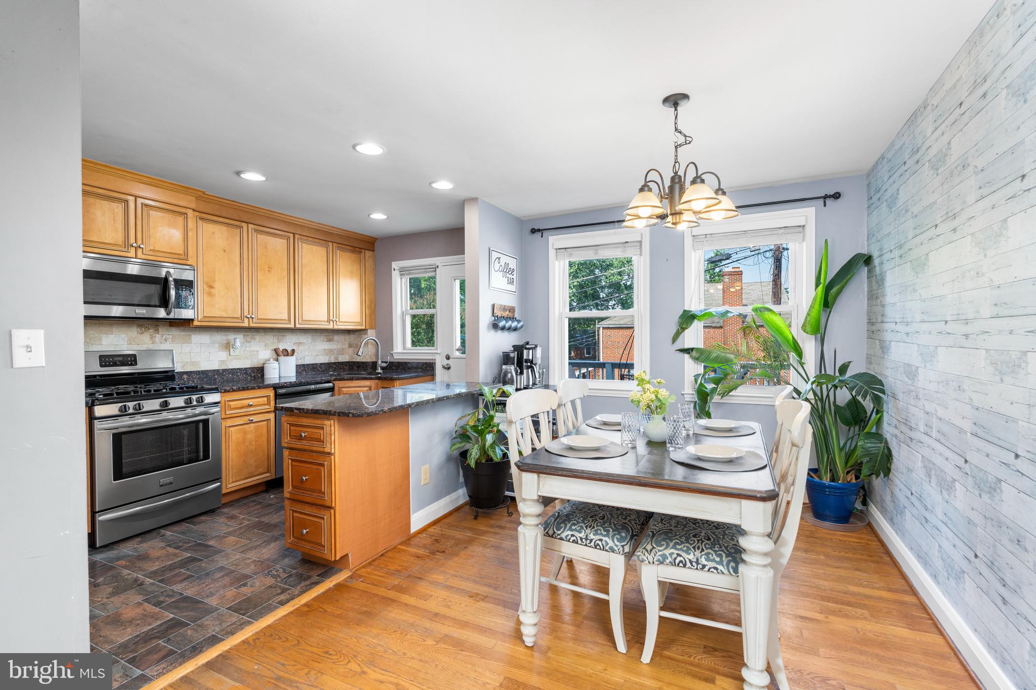 1606 Loch Ness Road Baltimore, MD 21286 - Photo 6 of 36 a kitchen with a table chairs stove and cabinets
