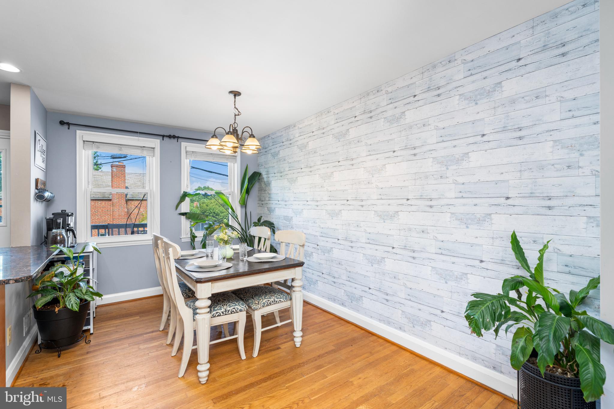 1606 Loch Ness Road Baltimore, MD 21286 - Photo 7 of 36 a dining room with furniture potted plants and wooden floor