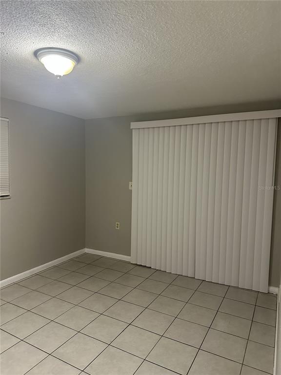 5509 Riddle Road Holiday, FL 34690 - Photo 12 of 13 an empty room with a wooden door and shower