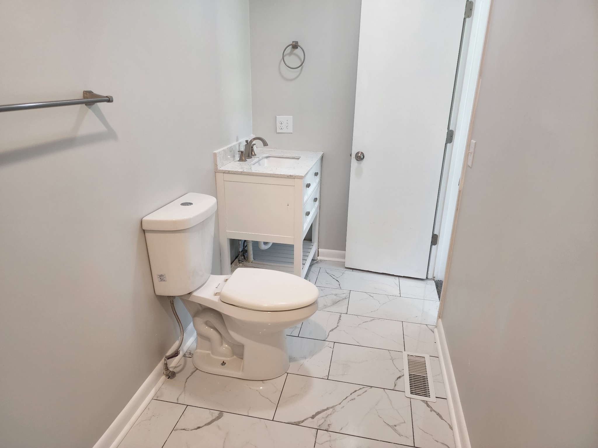 514 West Point Road Lawrenceburg, TN 38464 - Photo 16 of 25 a white toilet sitting next to a bathroom sink and vanity