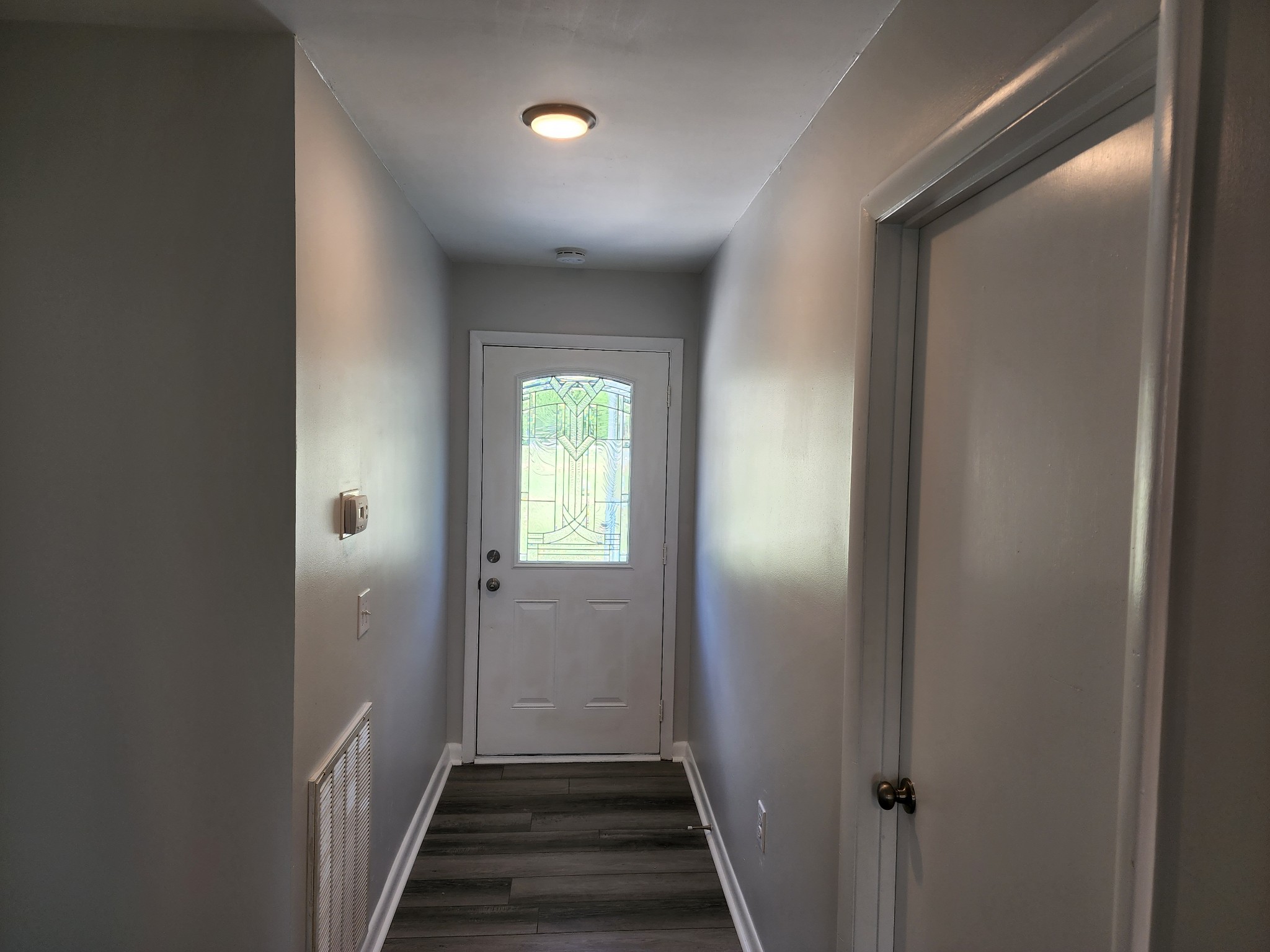 514 West Point Road Lawrenceburg, TN 38464 - Photo 5 of 25 a view of a hallway with wooden floor and a bathroom