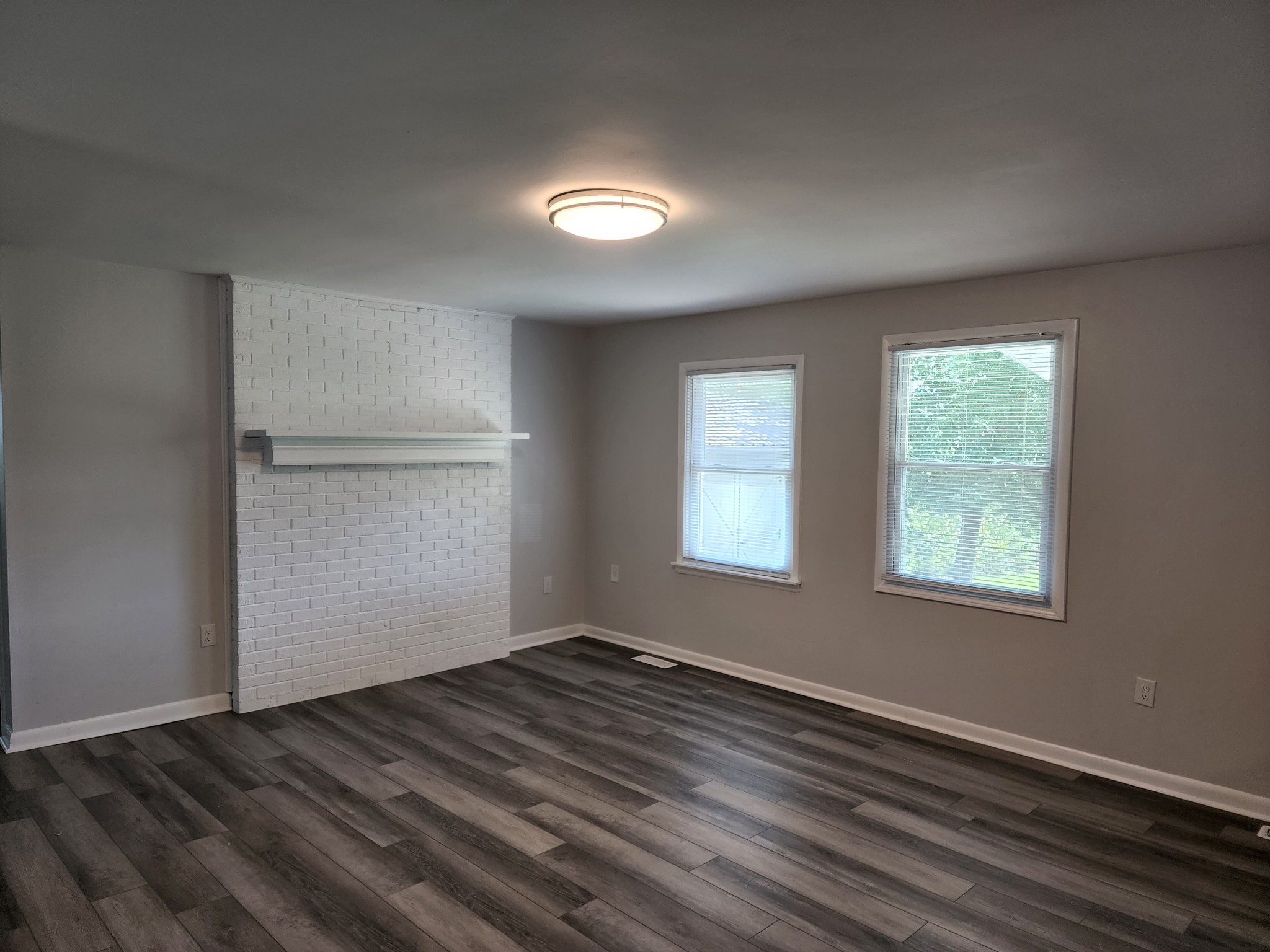 514 West Point Road Lawrenceburg, TN 38464 - Photo 6 of 25 an empty room with wooden floor and windows