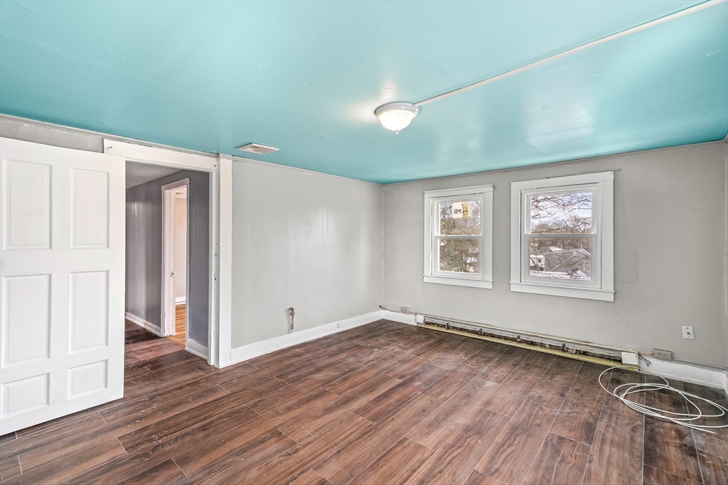 184 Myrtle Street Brockton, MA 02301 - Photo 14 of 41 an empty room with wooden floor and windows