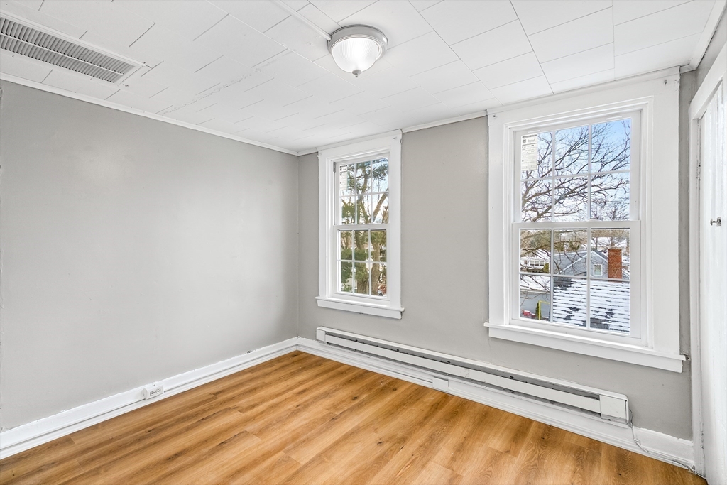184 Myrtle Street Brockton, MA 02301 - Photo 15 of 41 a view of an empty room with a window and wooden floor