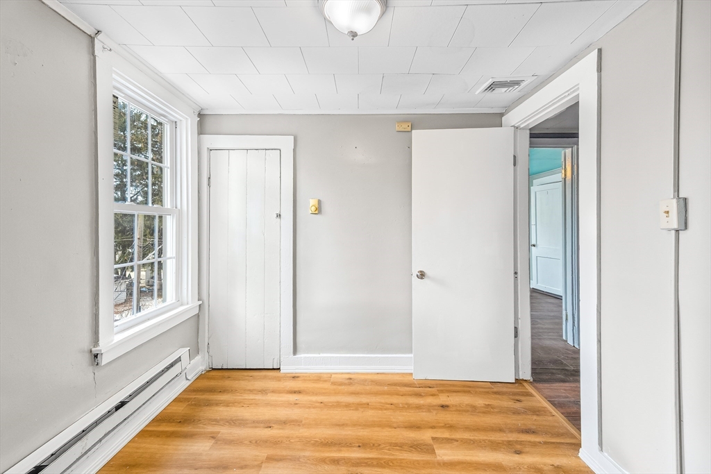 184 Myrtle Street Brockton, MA 02301 - Photo 16 of 41 a view of an empty room with wooden floor and a window