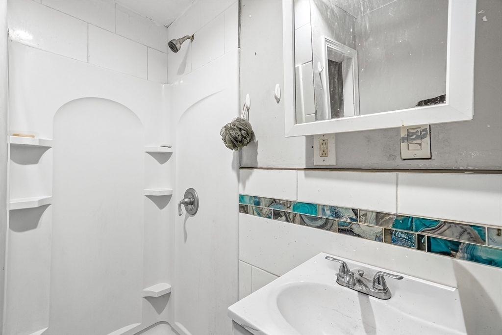 184 Myrtle Street Brockton, MA 02301 - Photo 18 of 41 a bathroom with a sink and a mirror