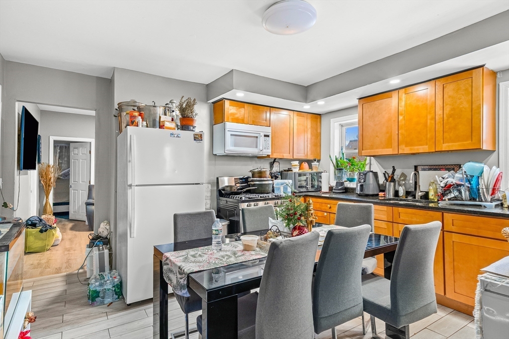 184 Myrtle Street Brockton, MA 02301 - Photo 19 of 41 a living room with furniture a fireplace and a kitchen view