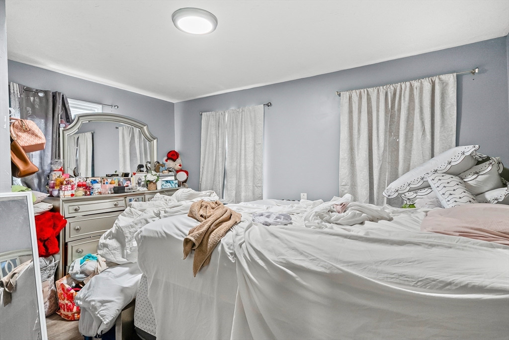 184 Myrtle Street Brockton, MA 02301 - Photo 23 of 41 a bed room with a bed mirror and a window