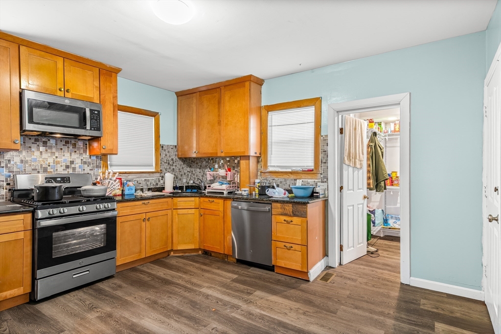 184 Myrtle Street Brockton, MA 02301 - Photo 30 of 41 a kitchen with stainless steel appliances granite countertop a stove top oven and sink