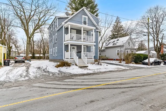 a view of white house with a snow on the road