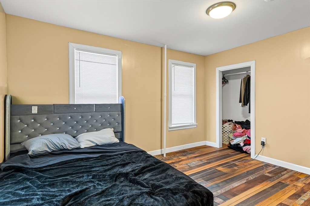 184 Myrtle Street Brockton, MA 02301 - Photo 32 of 41 a bedroom with a bed and wooden floor