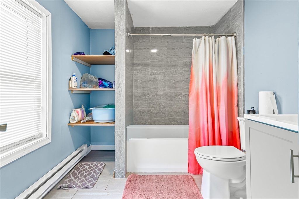 184 Myrtle Street Brockton, MA 02301 - Photo 36 of 41 a bathroom with a sink a toilet and shower curtain