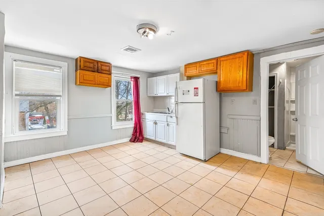 a view of a kitchen with an empty space and a window