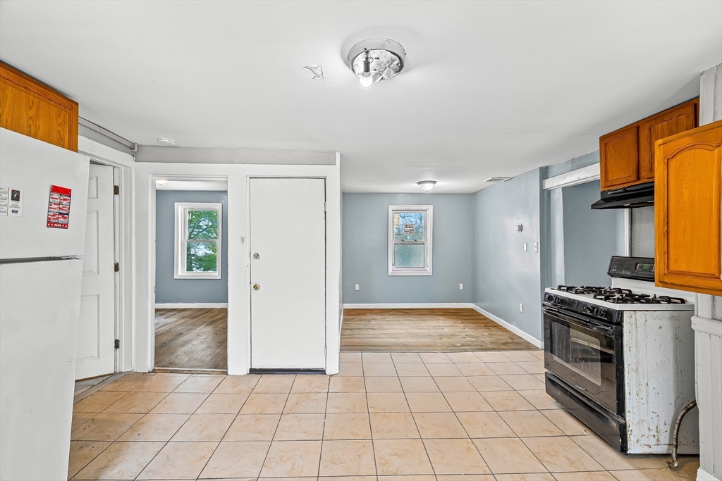 184 Myrtle Street Brockton, MA 02301 - Photo 10 of 41 a view of a kitchen with an empty space and a window