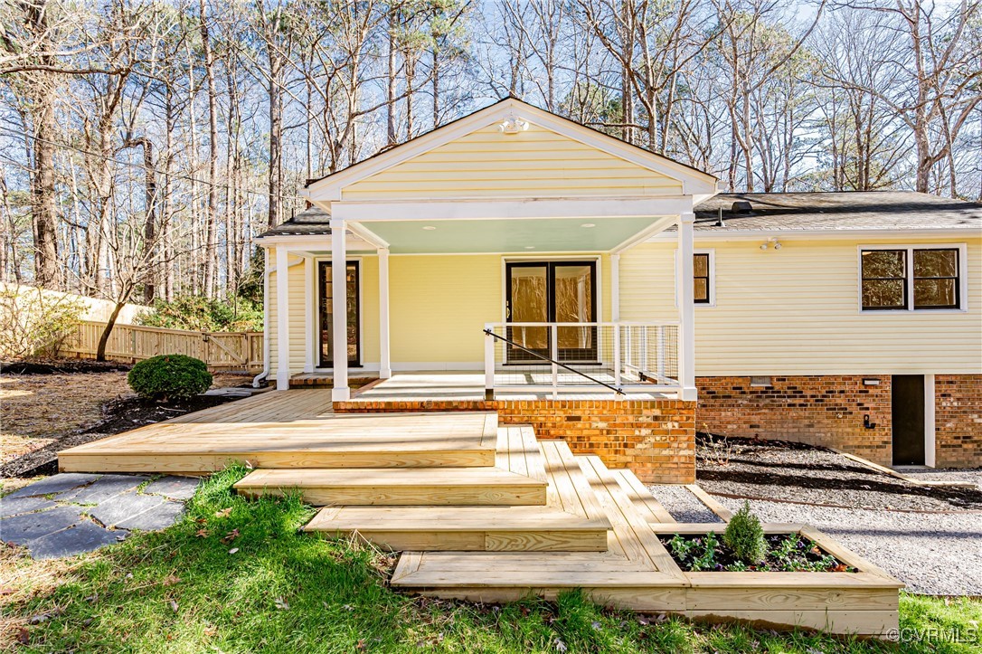 a view of a house with a patio and a yard