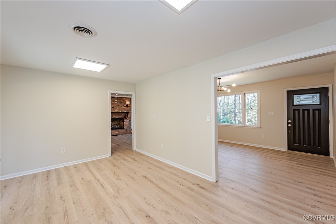 16120 Rowlett Road Chesterfield, VA 23838 - Photo 8 of 25 an empty room with wooden floor closet and windows