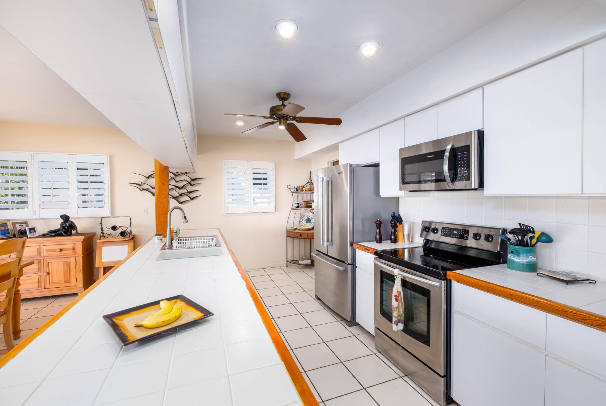 149 Lake Road Tavernier, FL 33070 - Photo 13 of 59 a kitchen with stainless steel appliances granite countertop a stove cabinets and living room view