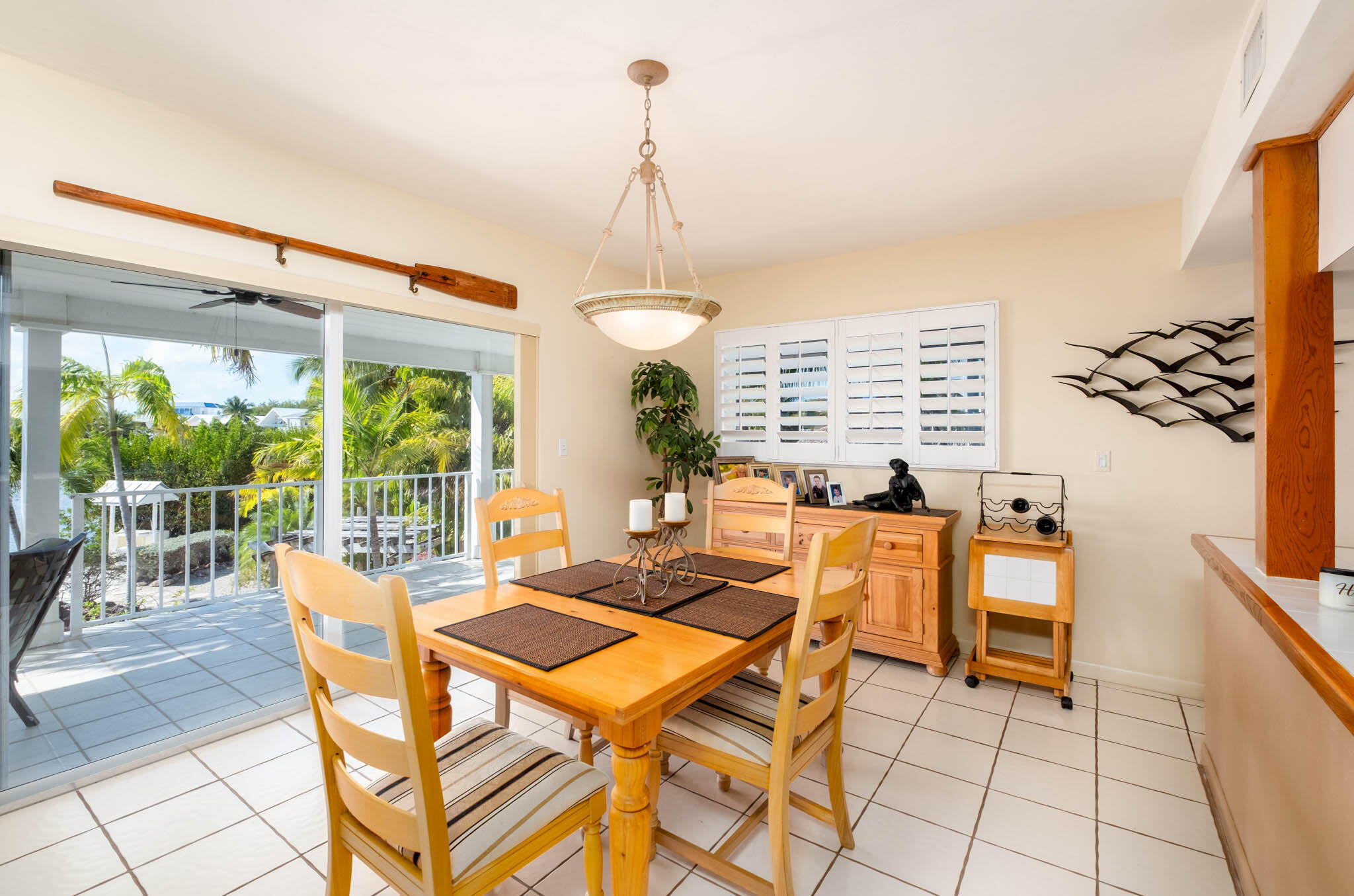 149 Lake Road Tavernier, FL 33070 - Photo 14 of 59 a dining room with furniture a chandelier and wooden floor