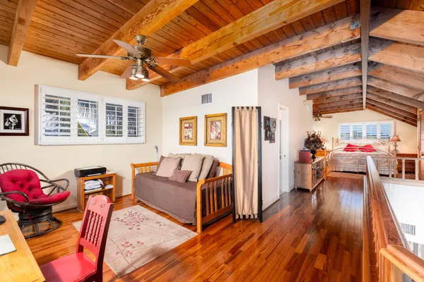 a bedroom with a bed dresser and a window