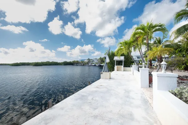 a view of house with yard and lake view